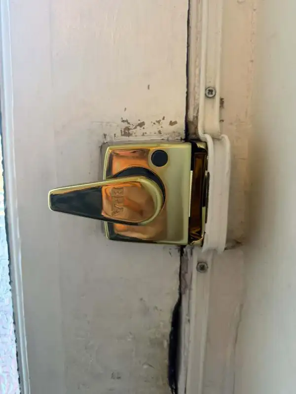 New ERA brass night latch fitted to a painted timber front door in Battersea